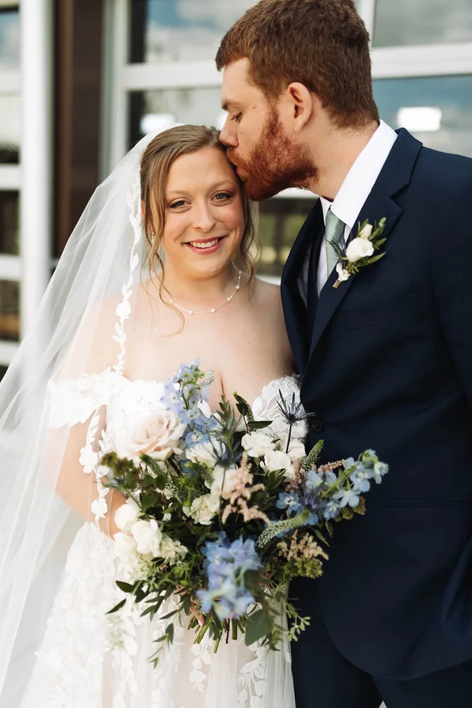 Ally and Jake sharing a kiss on their wedding day