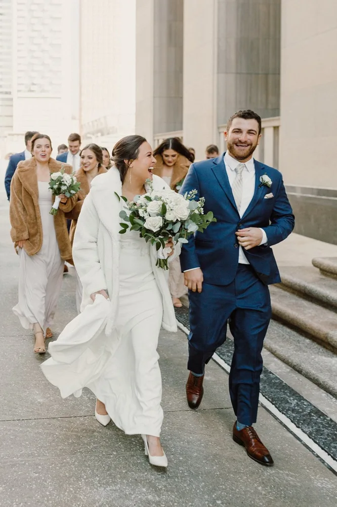 Hayley and Collin walking with their wedding party